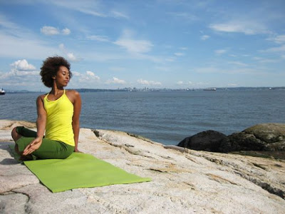 image of a yoga twist by the sea